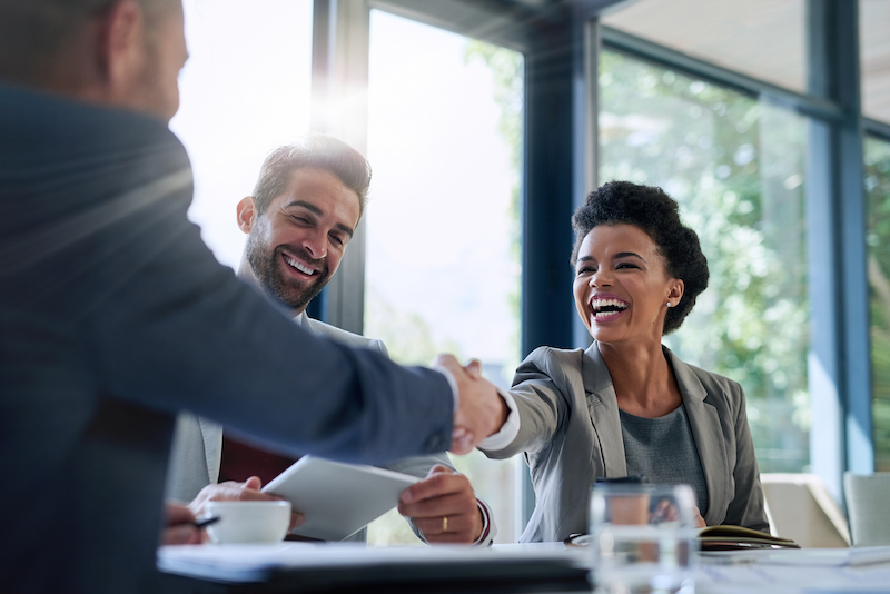 business people shaking hands in the office for a deal